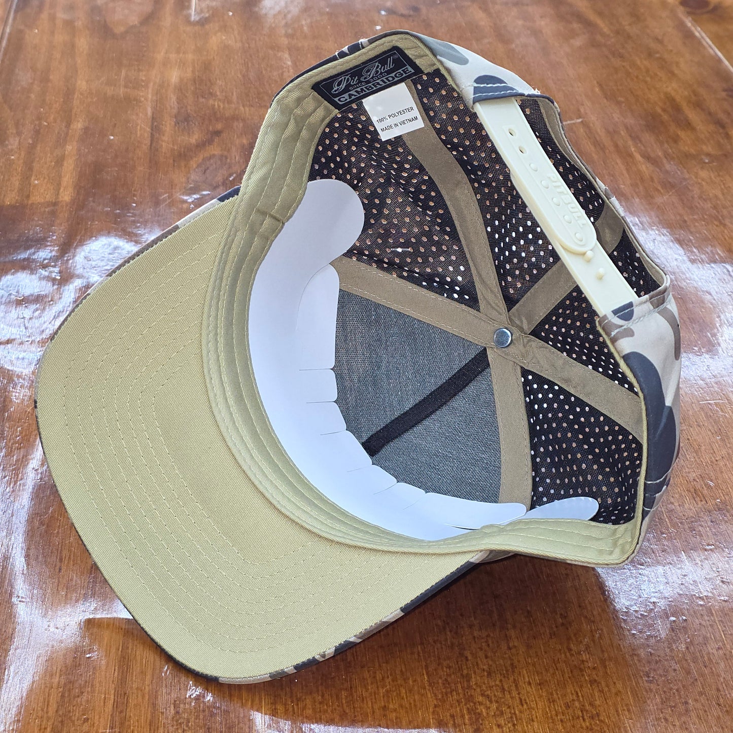 Baseball cap with mesh back on a wooden surface